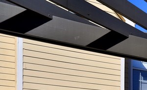 A stainless steel grill surrounded by granite counter space and light blue cabinetry at our outside community grill at Summit Pointe in Oklahoma City, Oklahoma